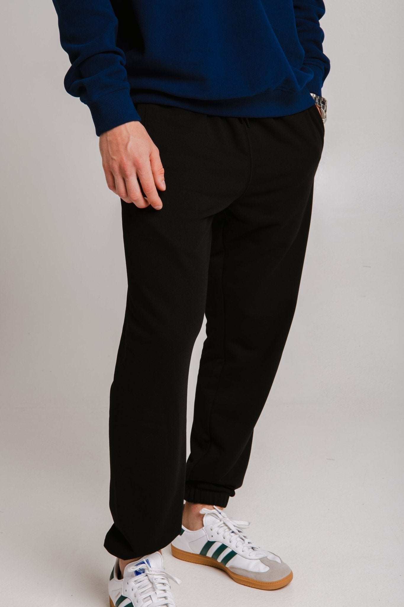 3. Unisex black Panda Soft Fleece Sweatpants by Sossu shown in side view in studio