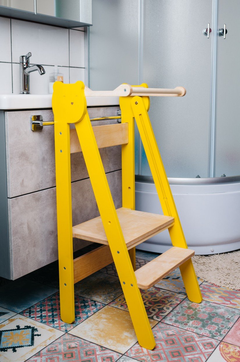 14. Yellow step stool placed in bathroom setting