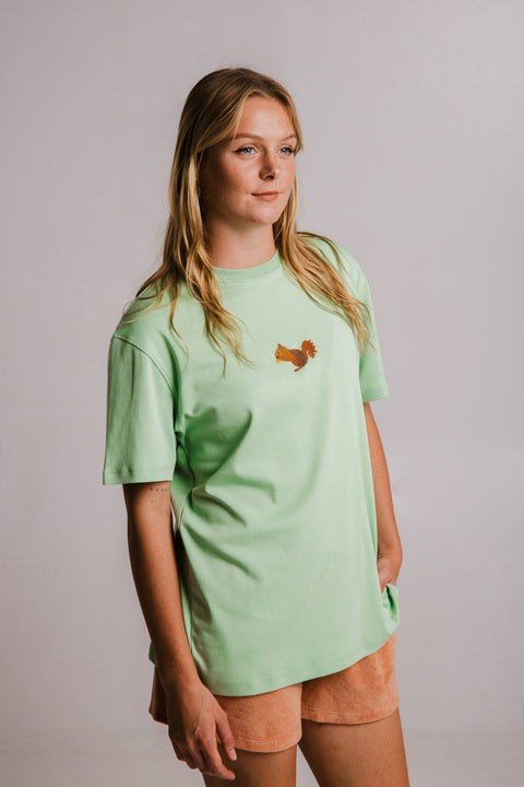 1. Women's Sossu Squirrel Heavy T-shirt in light green, shown in a studio setting with embroidered design