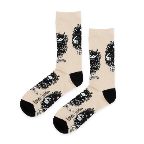 1. Men's beige Moomin Stinky Plotting socks by NordicBuddies, featuring playful design and black accents, shown in studio