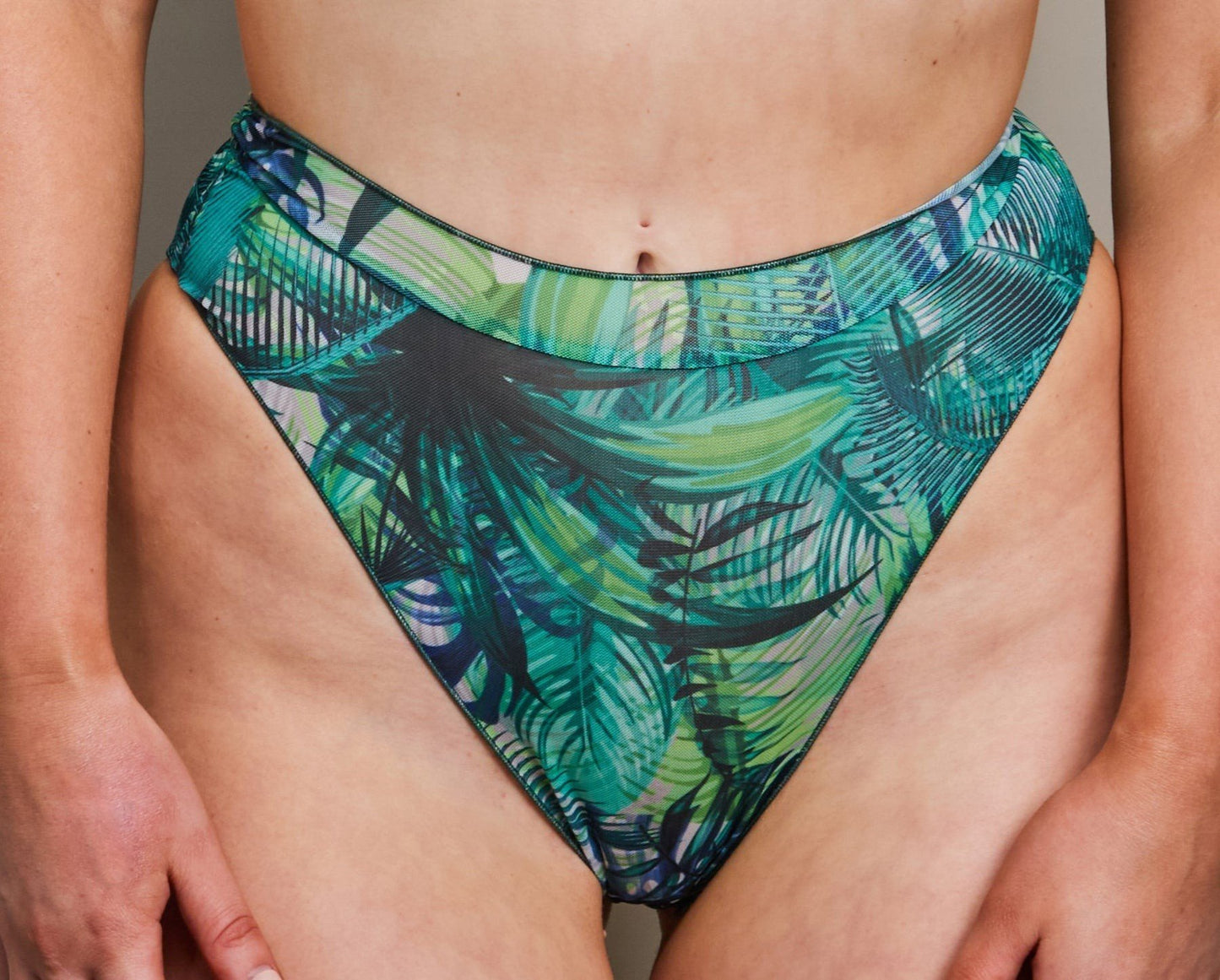 2. Close-up of women's tropical palm green high-waisted bikini bottoms by SWIMSARA