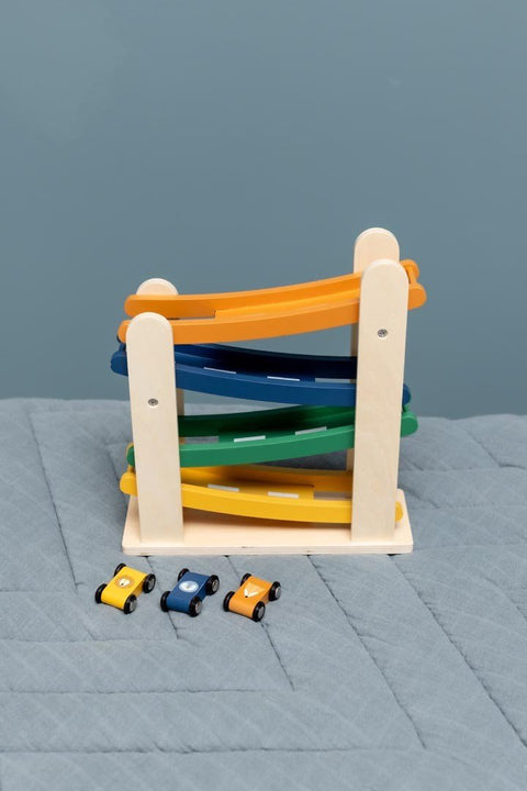 3. Trixie Baby wooden race track with animal cars on a blue quilted surface