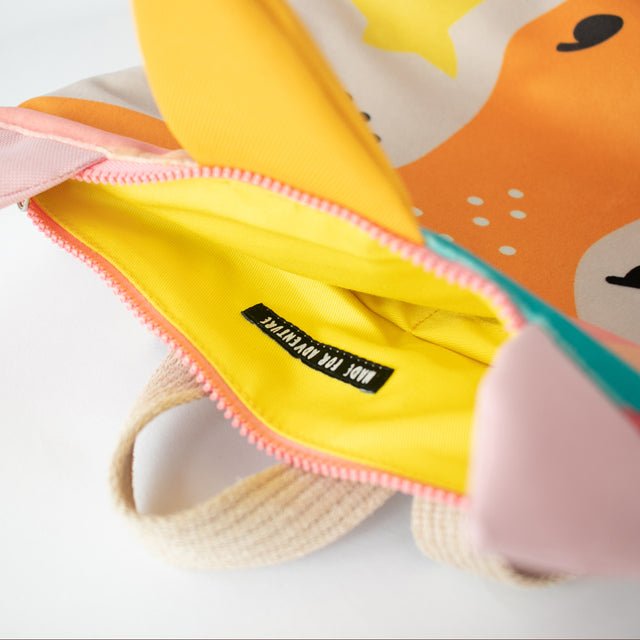 8. Close-up of MUNI Unicorn backpack interior, showing yellow lining and secure zipper closure