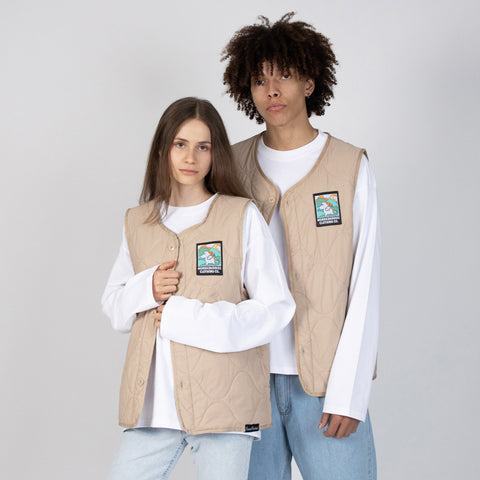 1. Man and woman wearing beige unisex vests with Moomintroll patch by NordicBuddies, styled with white shirts and jeans