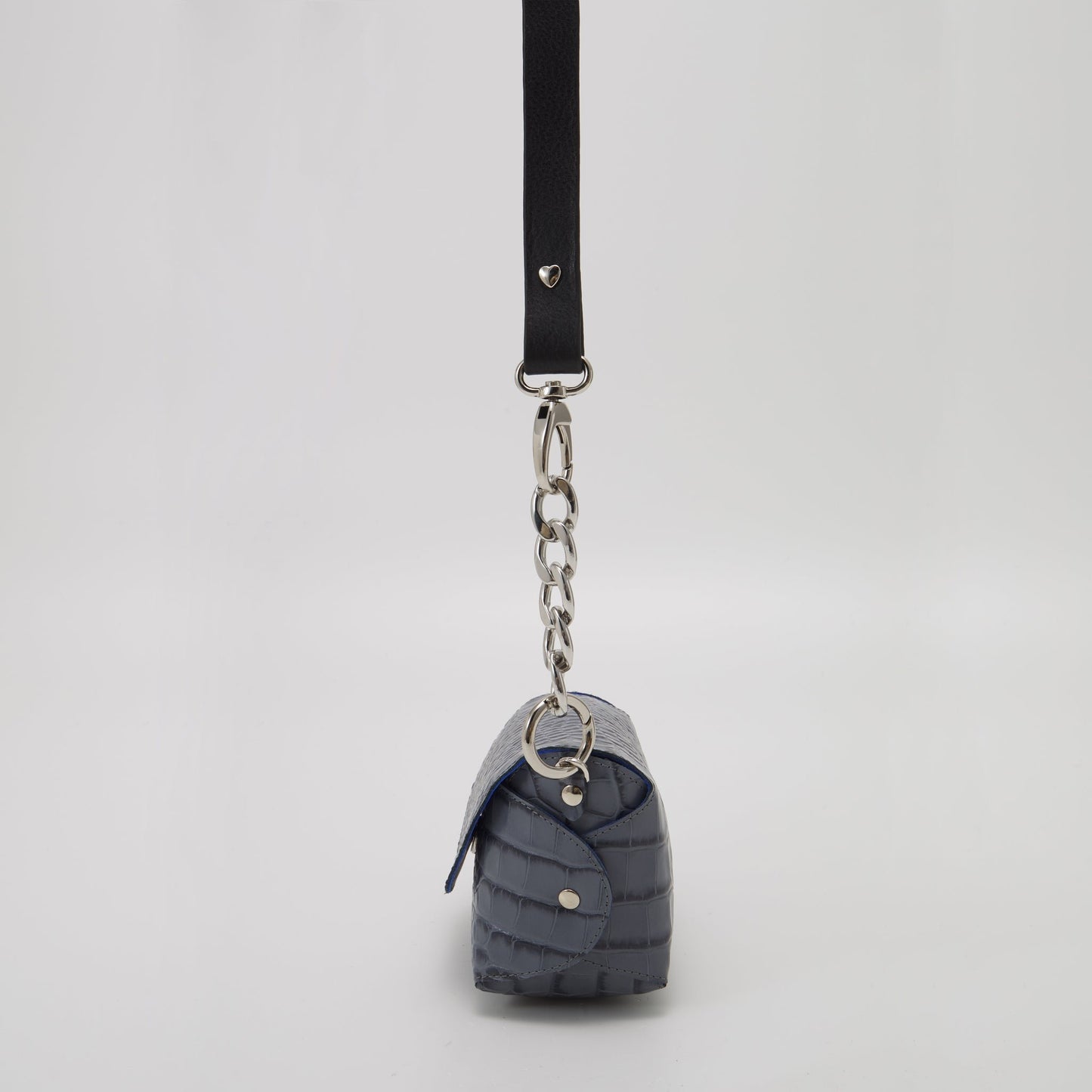 4. Studio shot of Daz Studio's handmade grey and blue leather shoulder bag, featuring adjustable strap and silver-toned hardware