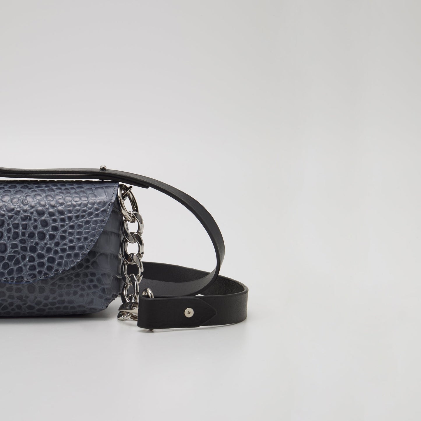 10. Close-up of Daz Studio's grey and blue textured leather shoulder bag, highlighting silver-toned hardware and detachable strap