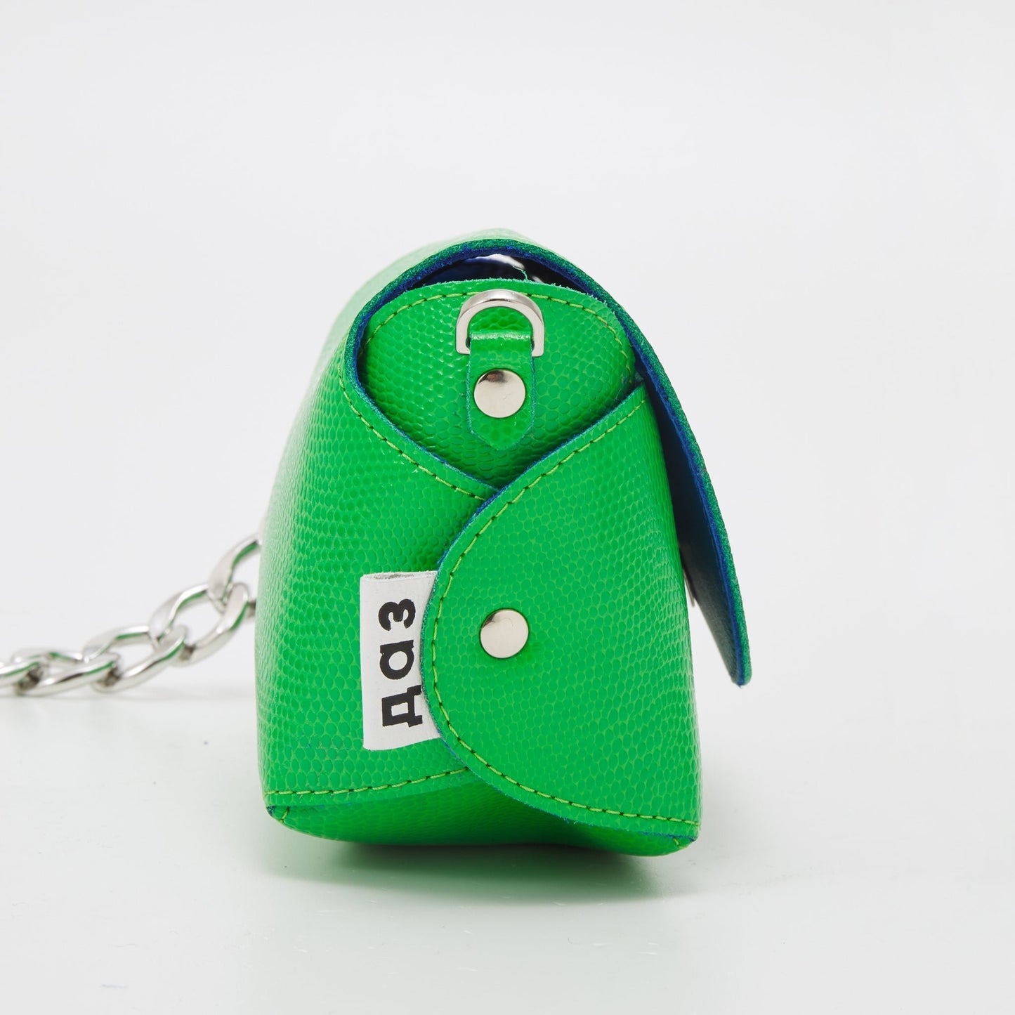6. Interior view of Daz Studio neon green leather shoulder bag with royal blue lining and magnetic closure