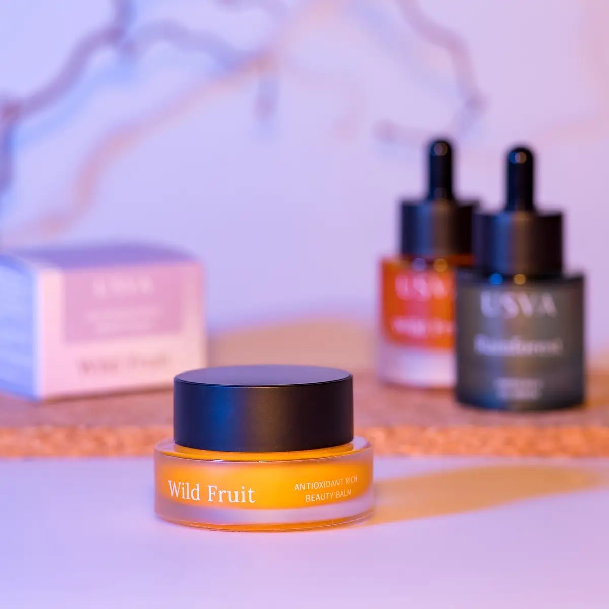 3. Usva Cosmetics Wild Fruit Beauty Balm with additional skincare products in background