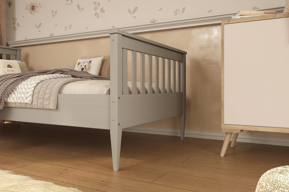 1. Gray wooden bed in a cozy bedroom setting with floral wallpaper and wooden flooring