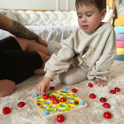 1. Child playing with Woopie Let's Go Green wooden ladybug memory puzzle on a soft carpet