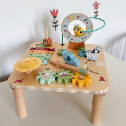 3. Woopie 5-in-1 wooden activity table on white surface with xylophone, bead maze, and animal shapes