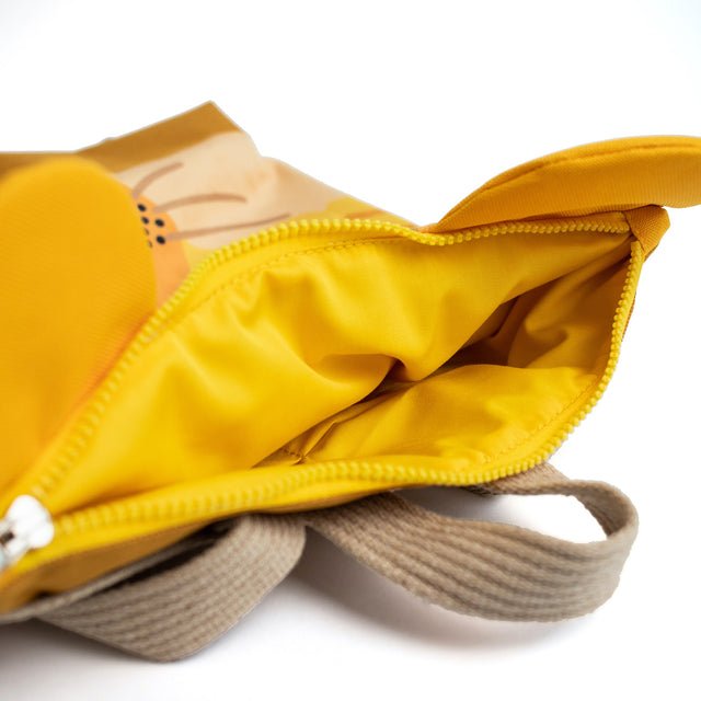 11. Close-up of Muni lion backpack interior with yellow lining