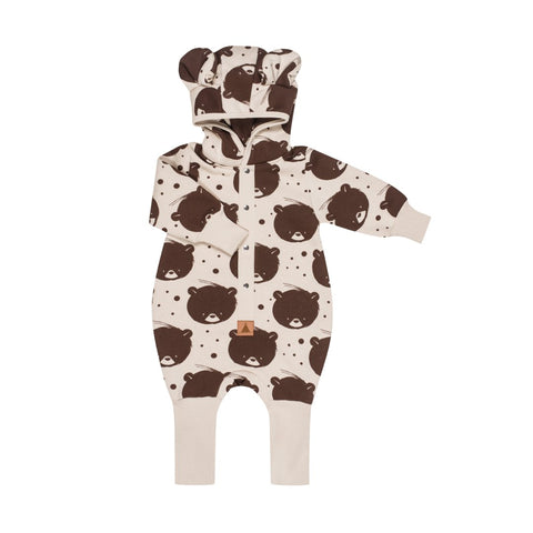 2. Beige bear-patterned jumpsuit with hood and ears laid flat on white background