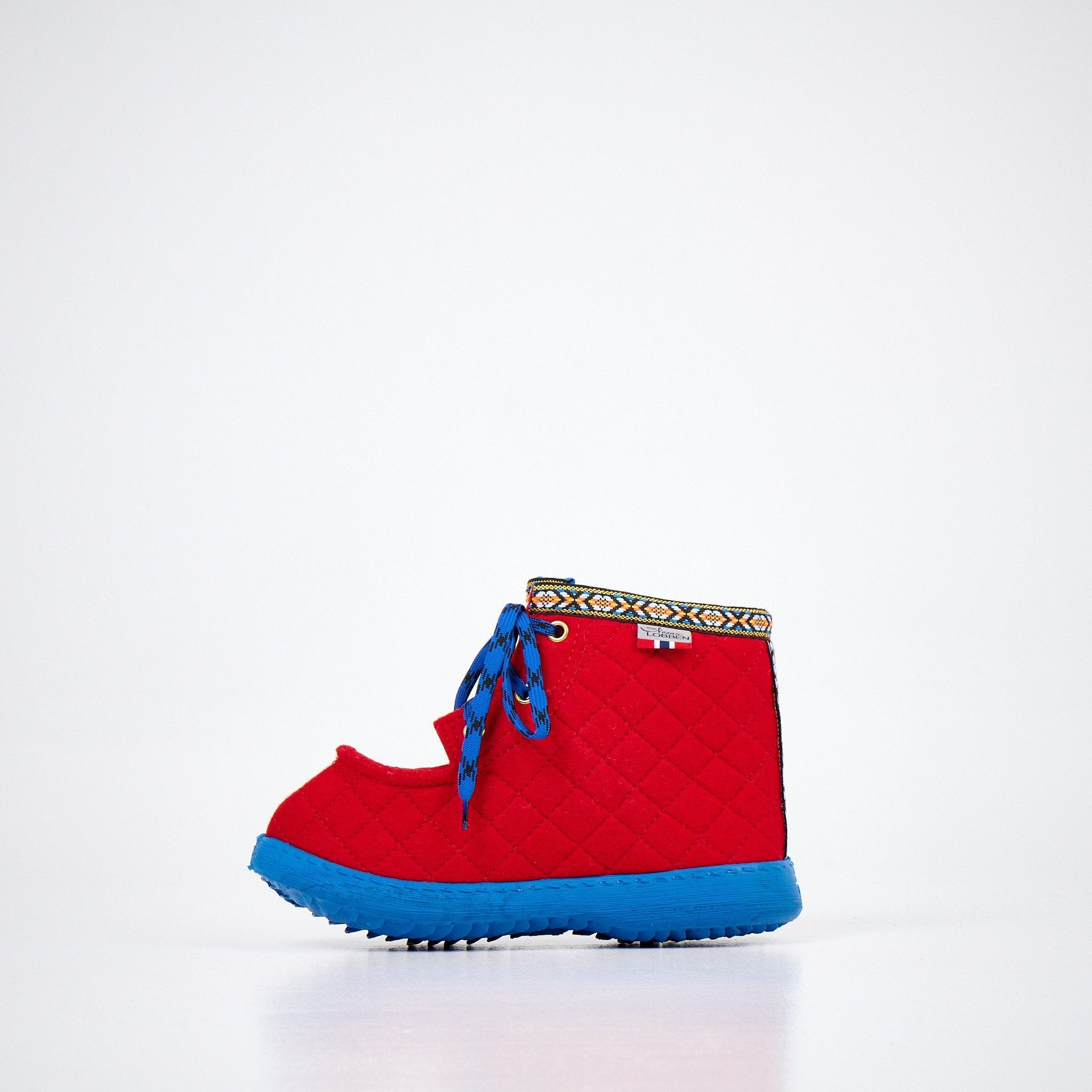 1. Studio shot of Nesna Lobben red felt boots with blue soles, featuring decorative trim and laces