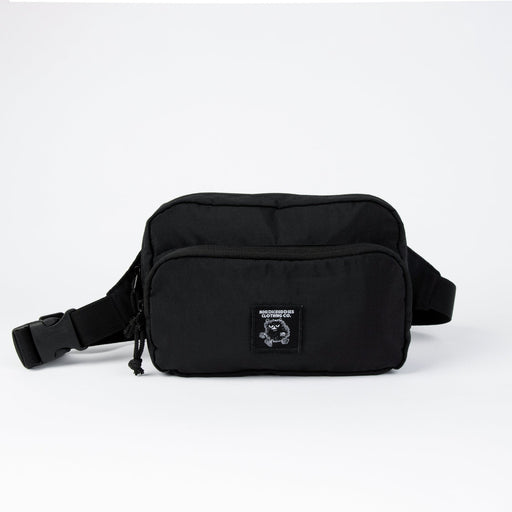 1. Woman wearing Nordhale OSLO Cross Body Bag in black, styled over white hoodie, shown from back in lifestyle setting