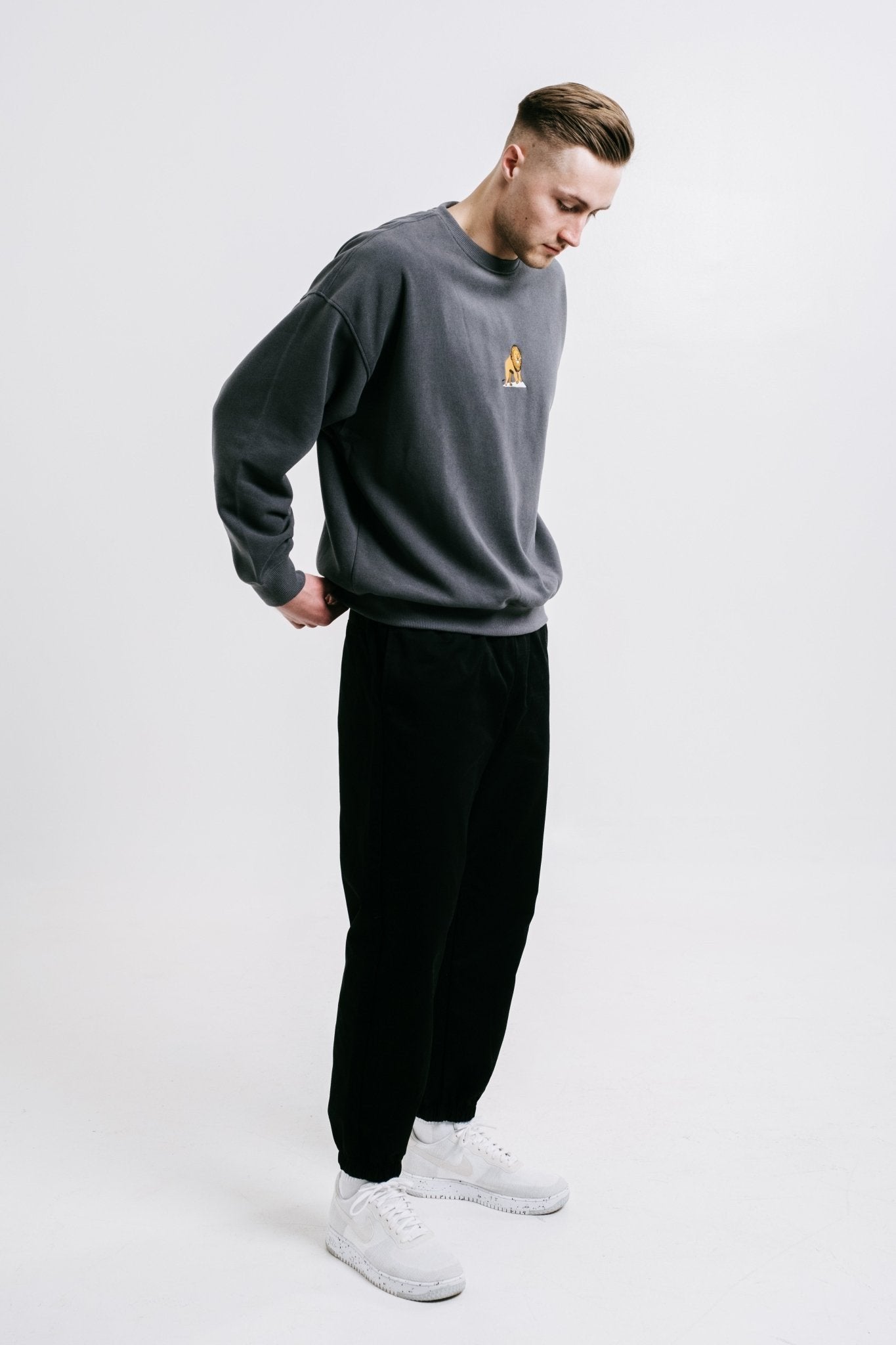 1. Unisex black Moomin Jungle t-shirt worn by male and female models, featuring bold back design and small front logo