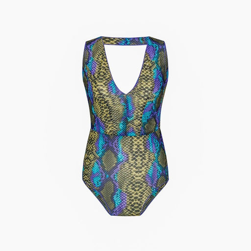 1. Woman wearing Smarttan Eeva Tropics Tan-Through Mini Leggings on the beach, showcasing floral design and tan-through fabric