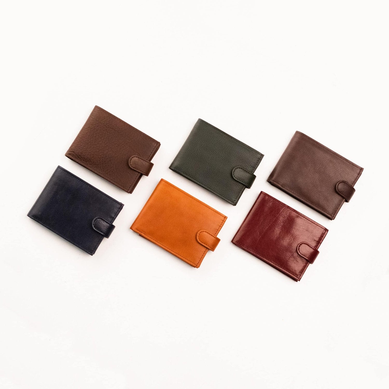 1. Woman holding Zelma Kraft black wristlet wallet with removable strap, shown in lifestyle setting