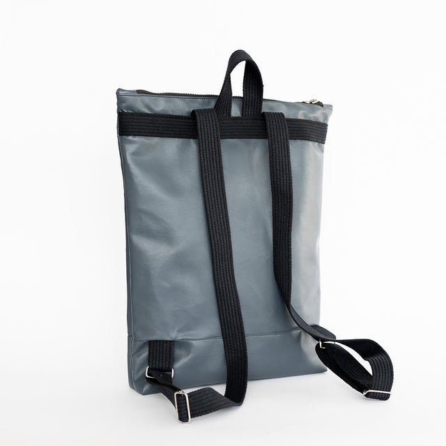 7. Back view of Muni grey faux leather backpack with adjustable straps