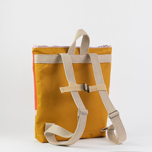 3. Back view of Muni kids backpack in yellow, showing adjustable shoulder and chest straps