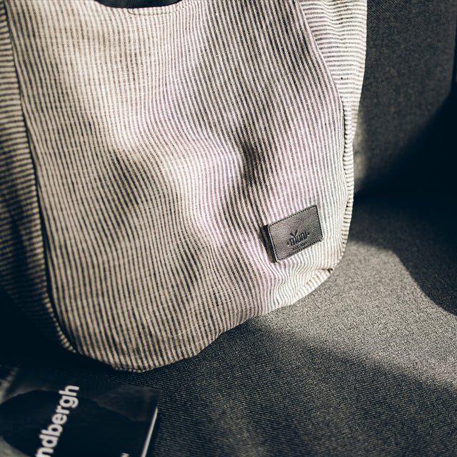 9. Muni striped linen tote bag on a sofa, highlighting texture