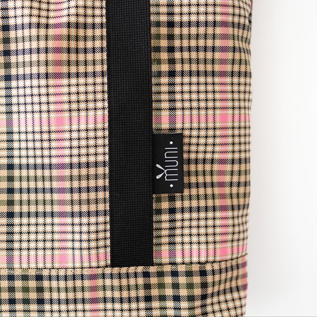 6. Close-up of Muni brand tag on tartan tote bag, showing detailed pattern and craftsmanship