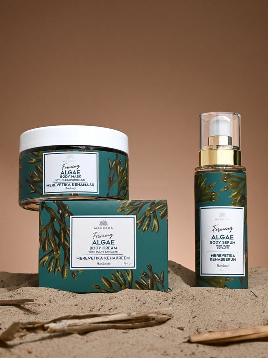 2. Magrada Firming Algae Body Mask, serum, and cream set on sand, highlighting organic ingredients
