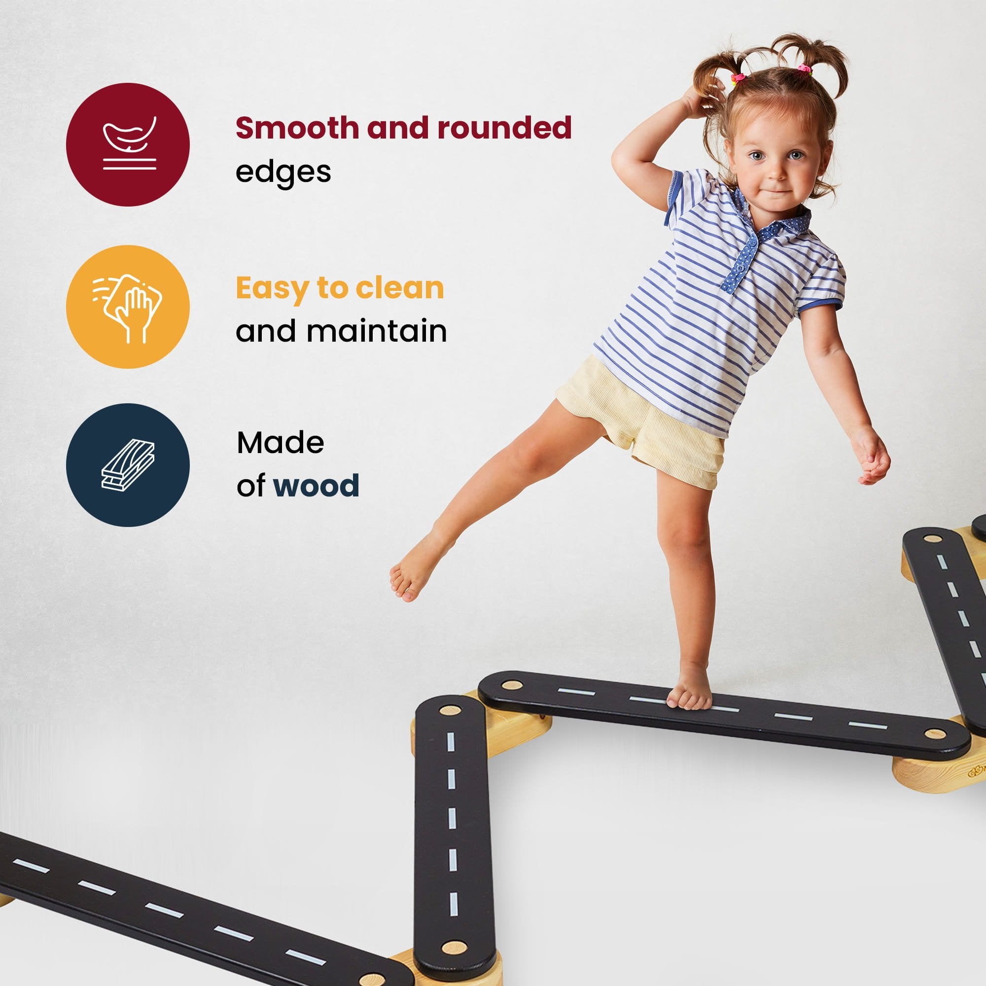 11. Young girl balancing on black wooden beam with road design, text highlighting smooth edges, easy maintenance, and wood material