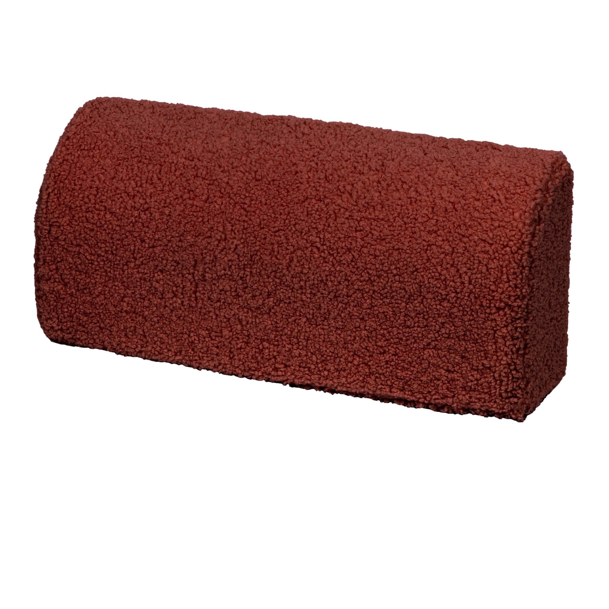 9. Close-up of a brown cylindrical pillow from the modular sofa, showing texture and material
