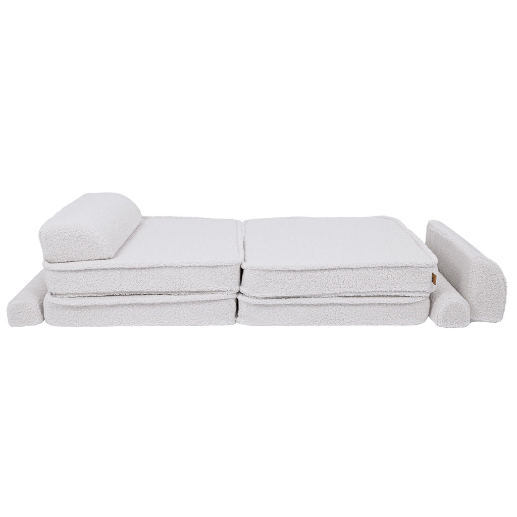 2. Large modular children's sofa in bearly white shown in a flat position with cushions rearranged