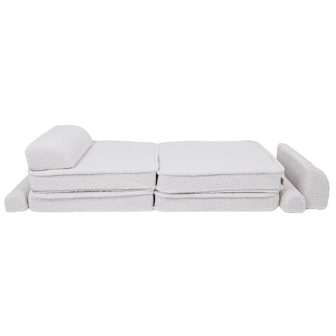 2. Large modular children's sofa in bearly white shown in a flat position with cushions rearranged