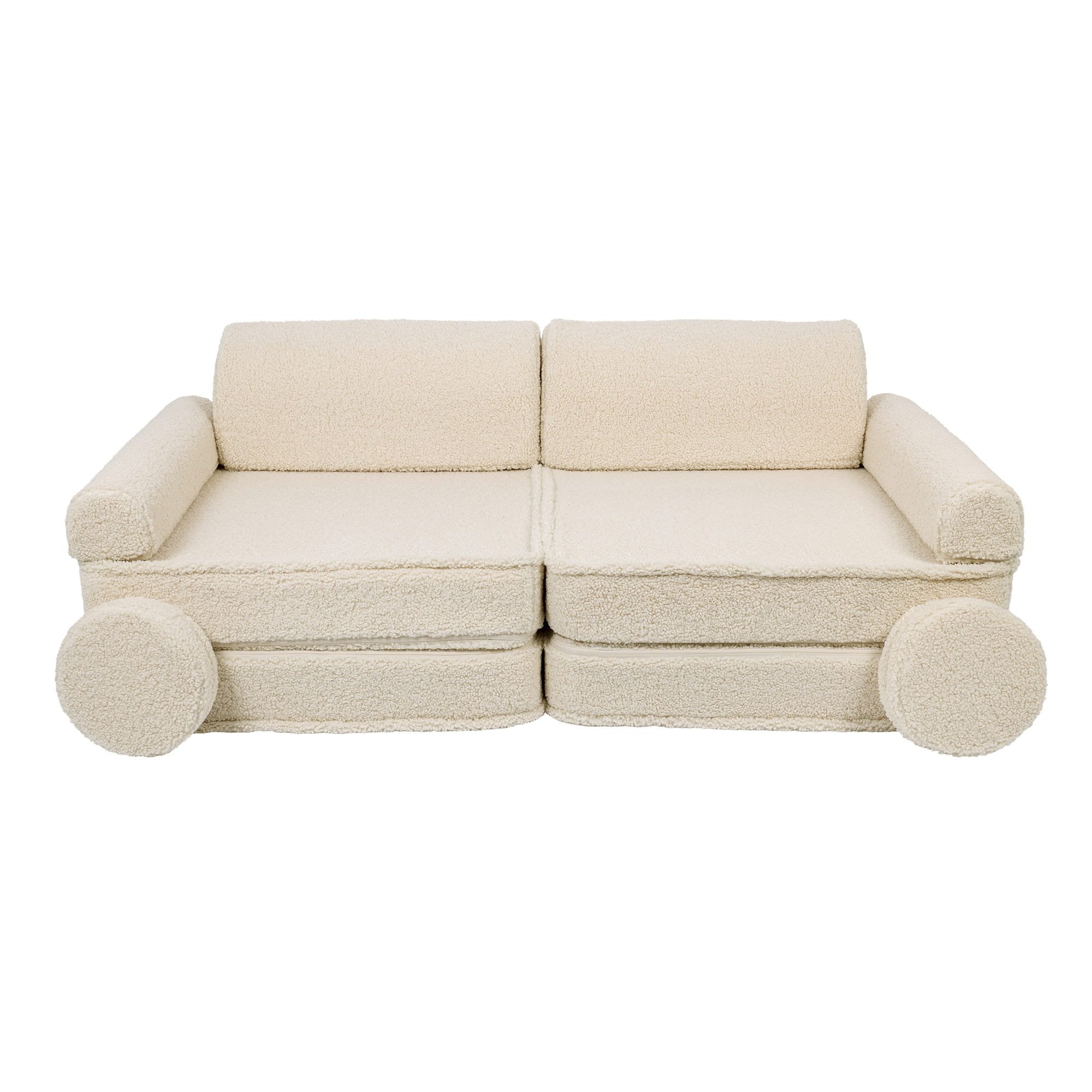 1. Cream modular children's sofa with rounded armrests and circular cushions, shown in a studio setting