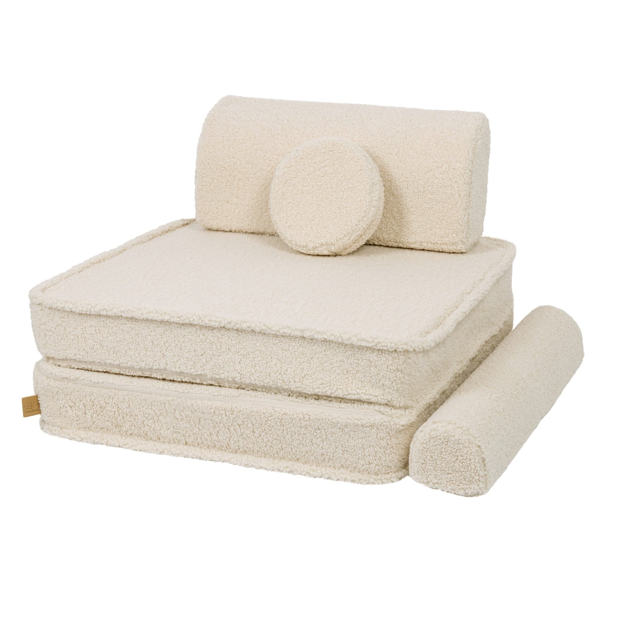 6. Cream modular sofa arranged as a single seat with backrest and circular cushion, in a studio setting
