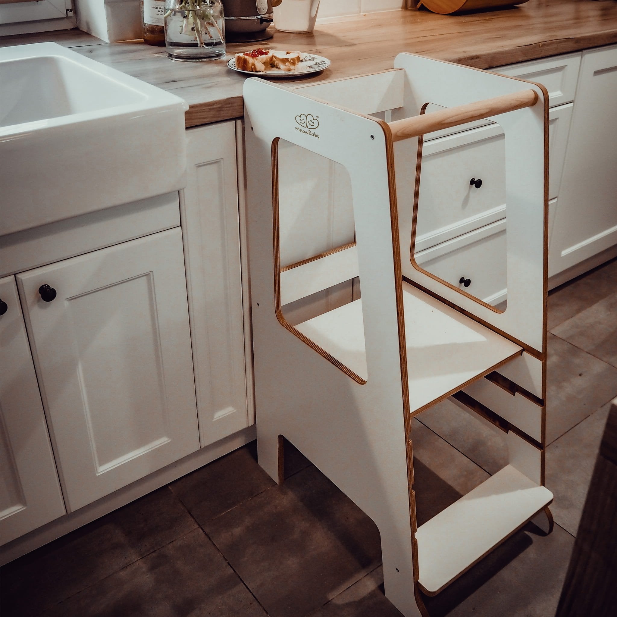 1. MeowBaby white kitchen helper placed next to a kitchen counter in a home setting