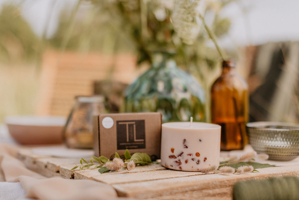 7. TL Candles hand-made soy wax candle with amber pieces, shown on mossy wood, highlighting natural elements