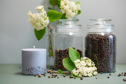 3. Hand-made soy wax candle by TL Candles, featuring patchouli scent, displayed with black pepper and myrtle