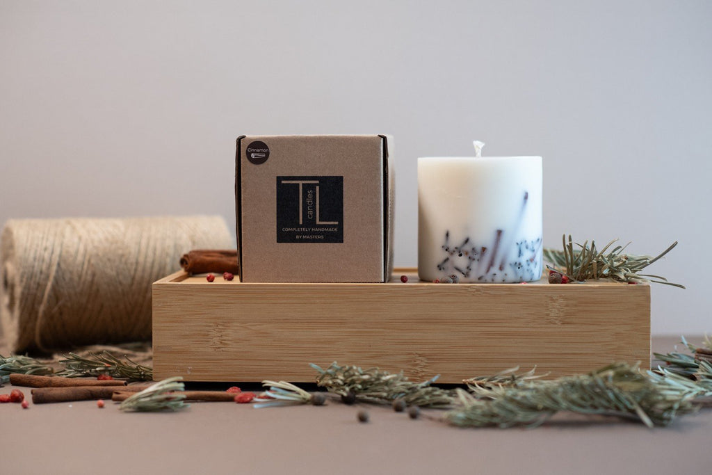 3. TL Candles soy wax candle with packaging on wooden tray, featuring cinnamon and clove accents