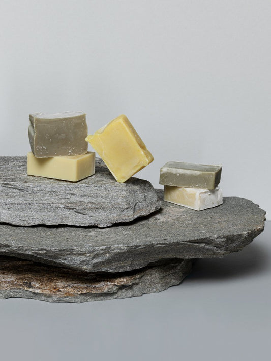 2. Assorted Magrada Organic Cosmetics soaps including lemon and mint variant on stone