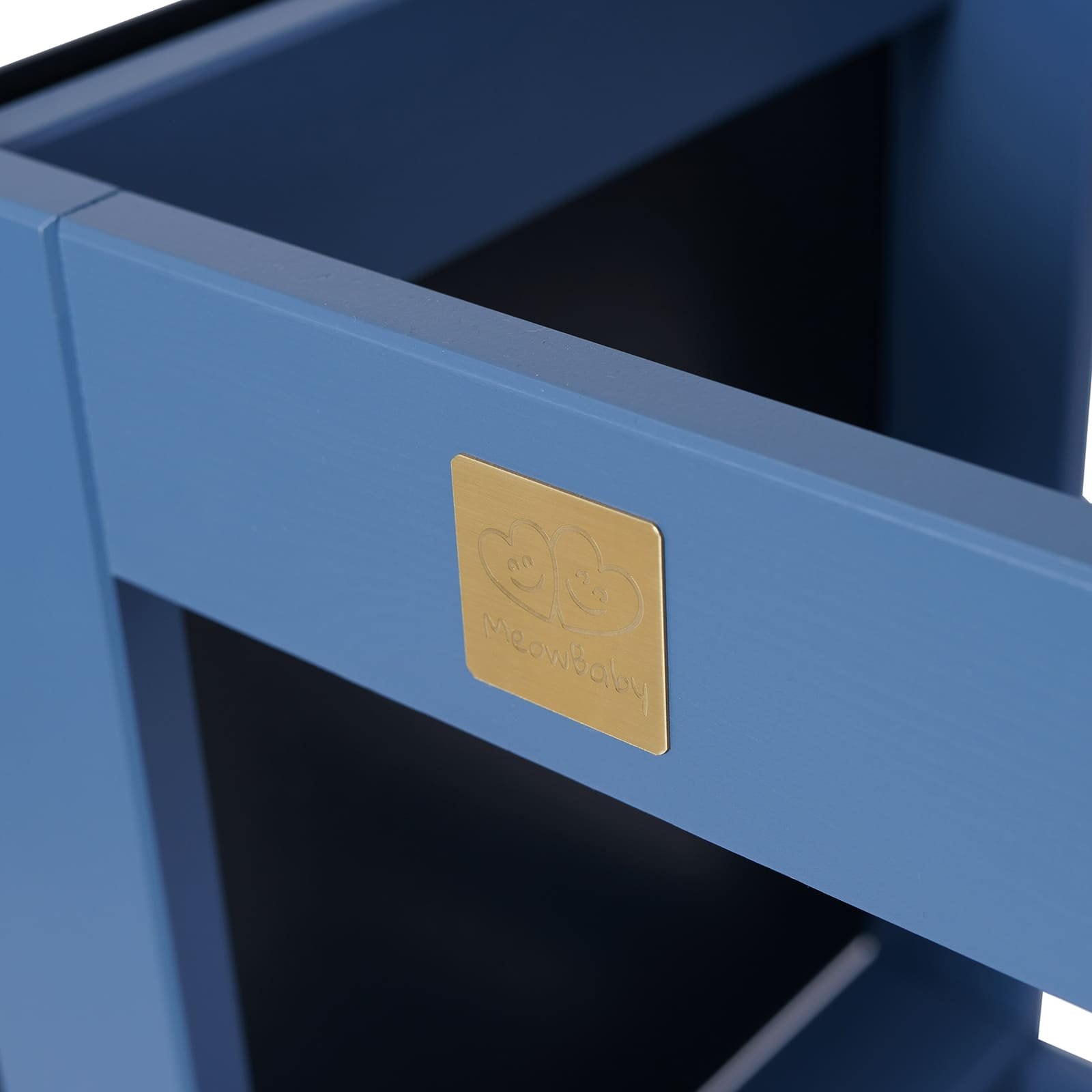 3. Close-up of MeowBaby logo on blue wooden kitchen helper