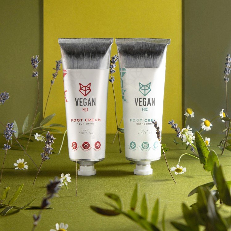 4. Vegan Fox Nourishing and Refreshing Foot Cream tubes in a botanical setting, emphasizing natural ingredients
