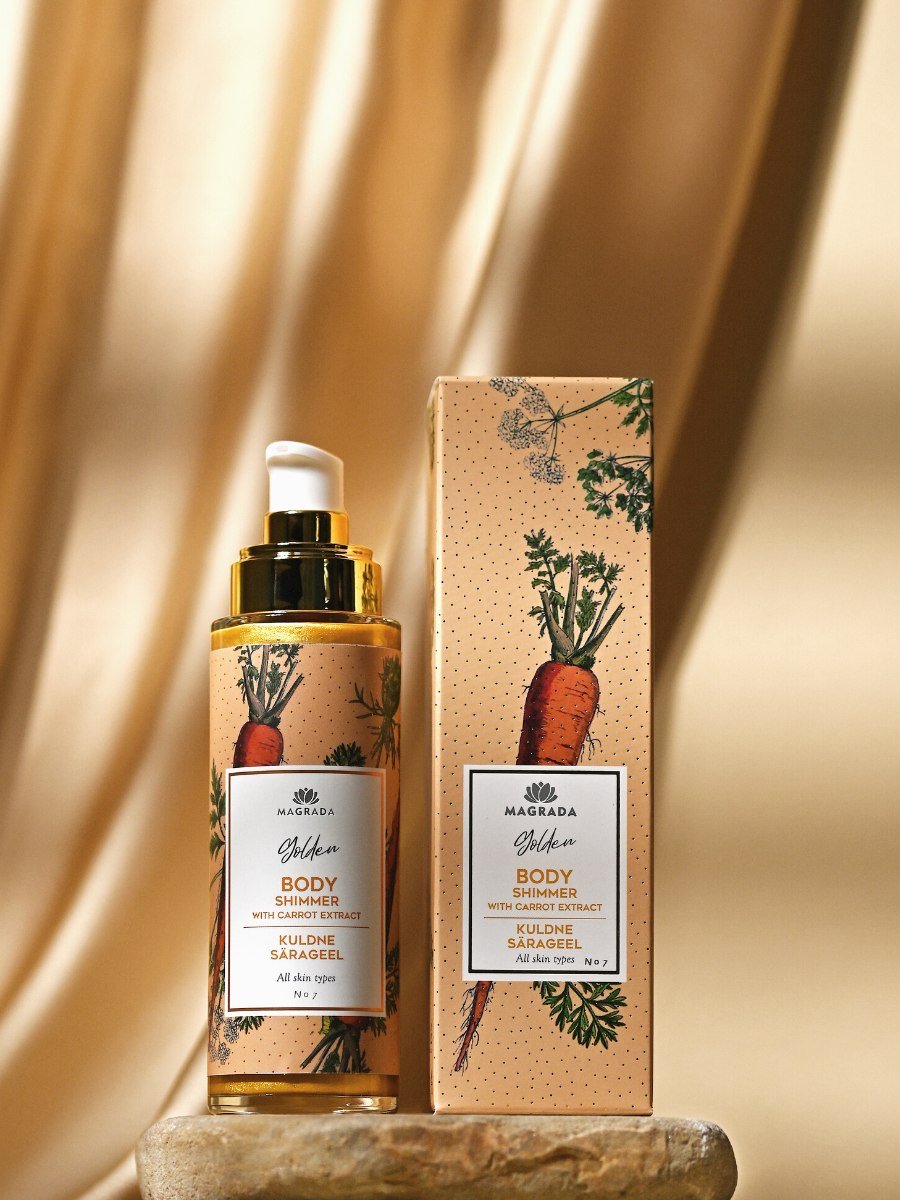 4. Magrada Golden Shimmer Gel with Carrot Extract bottle and packaging on textured surface in studio setting