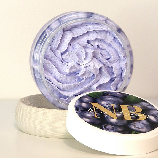1. Open jar of North Beauty Whipped Sugar Body Scrub with Blueberry, showing creamy texture and NB logo on lid