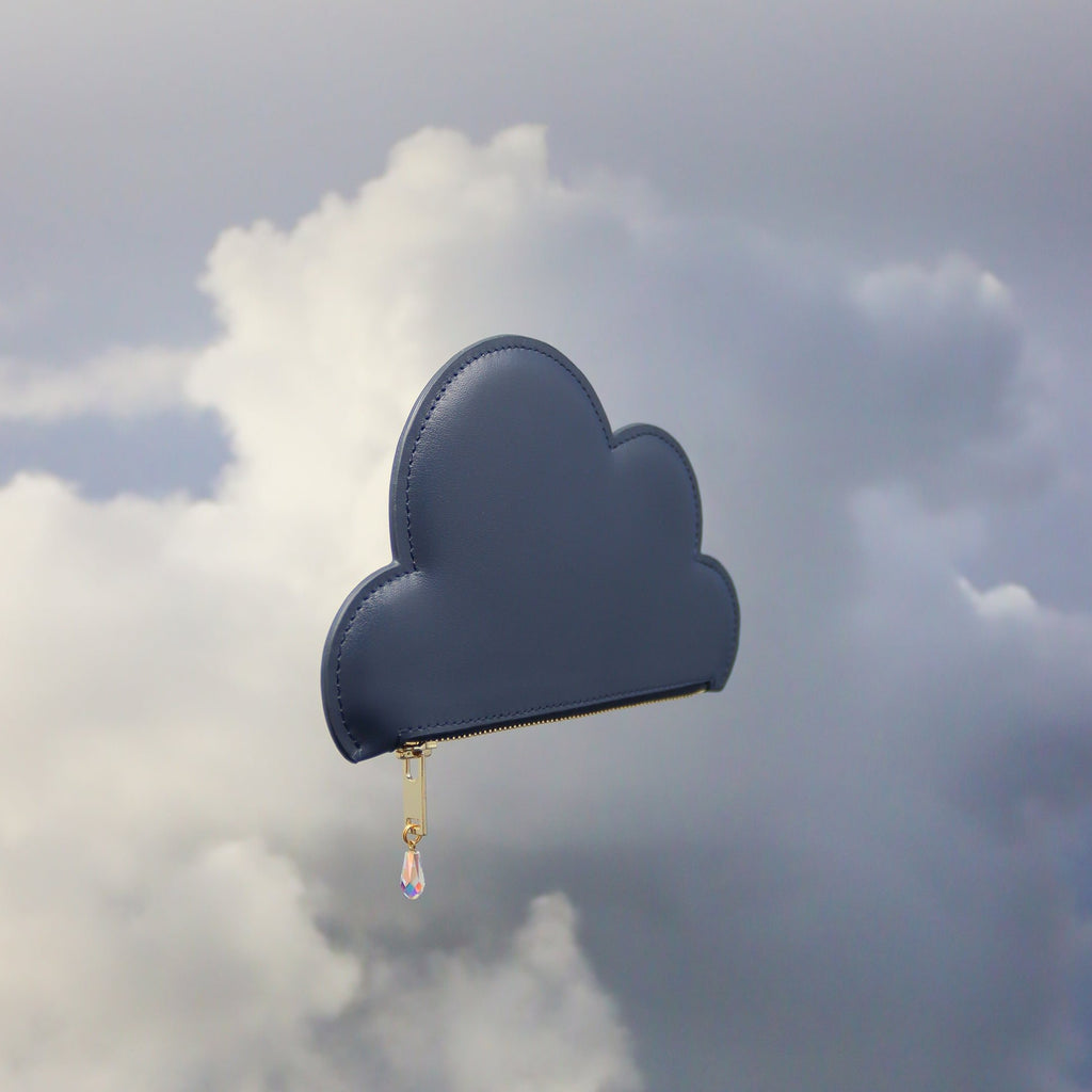 5. Tairi Roosve Leather Cloud Purse in navy with Swarovski crystal zip, shown in a cloudy sky setting