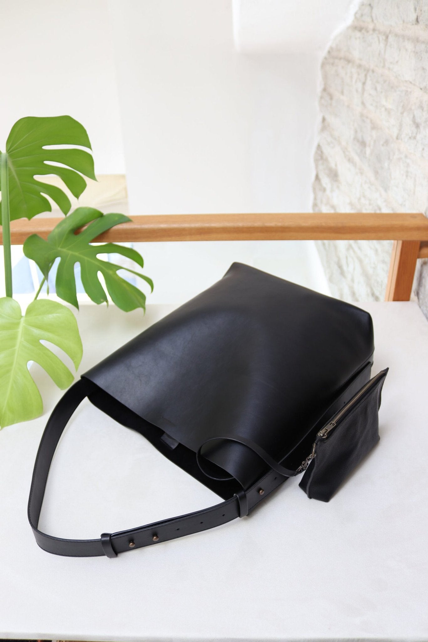 10. Close-up of Tairi Roosve black leather tote bag's adjustable strap and metal hardware