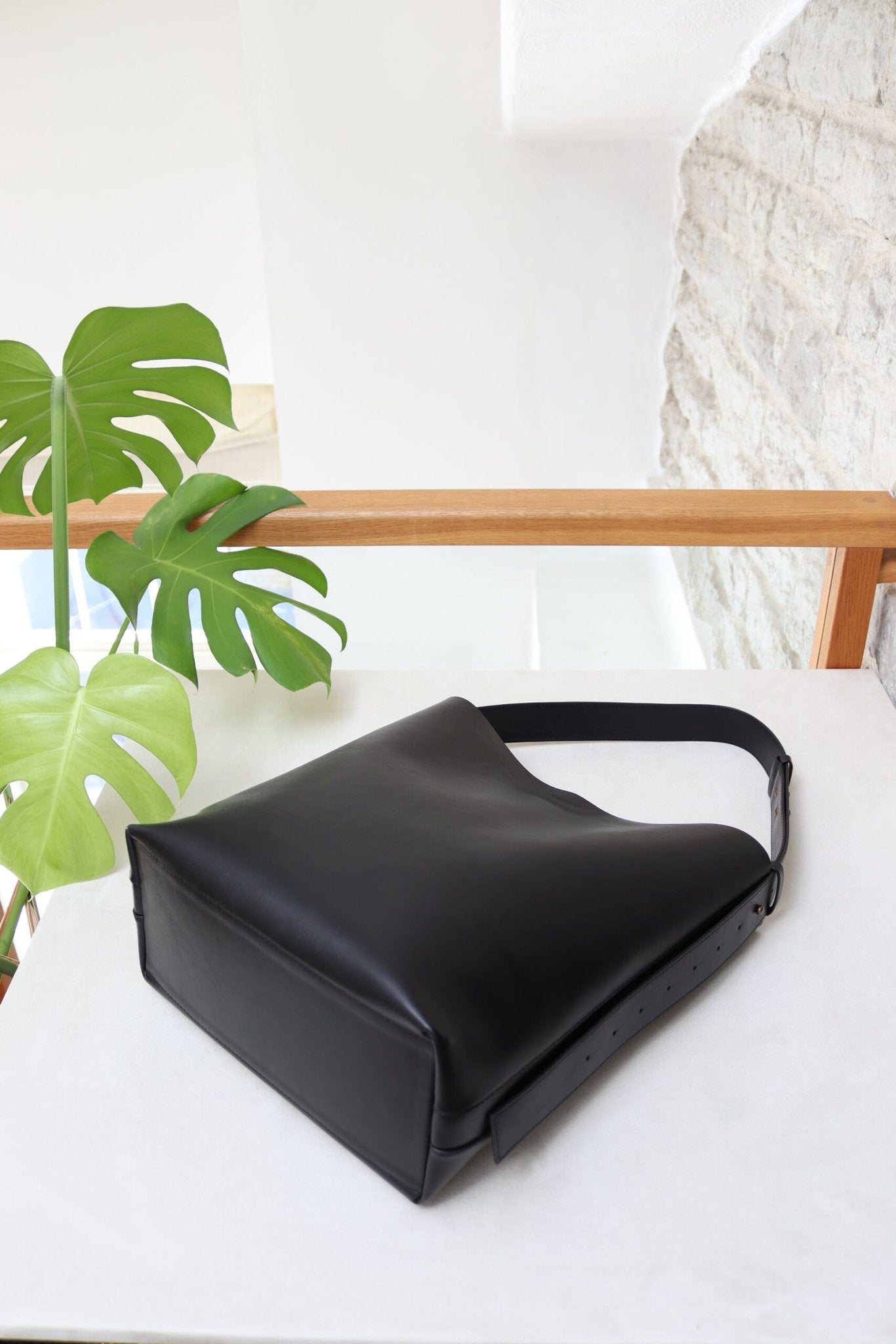 7. Bottom view of Tairi Roosve black leather tote bag, highlighting sturdy construction and material quality