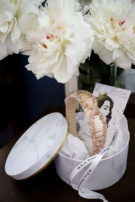 2. Eva Oherjus Mulberry Silk Headband Ada Thin in gift box with floral background, showcasing hand-beaded embellishments