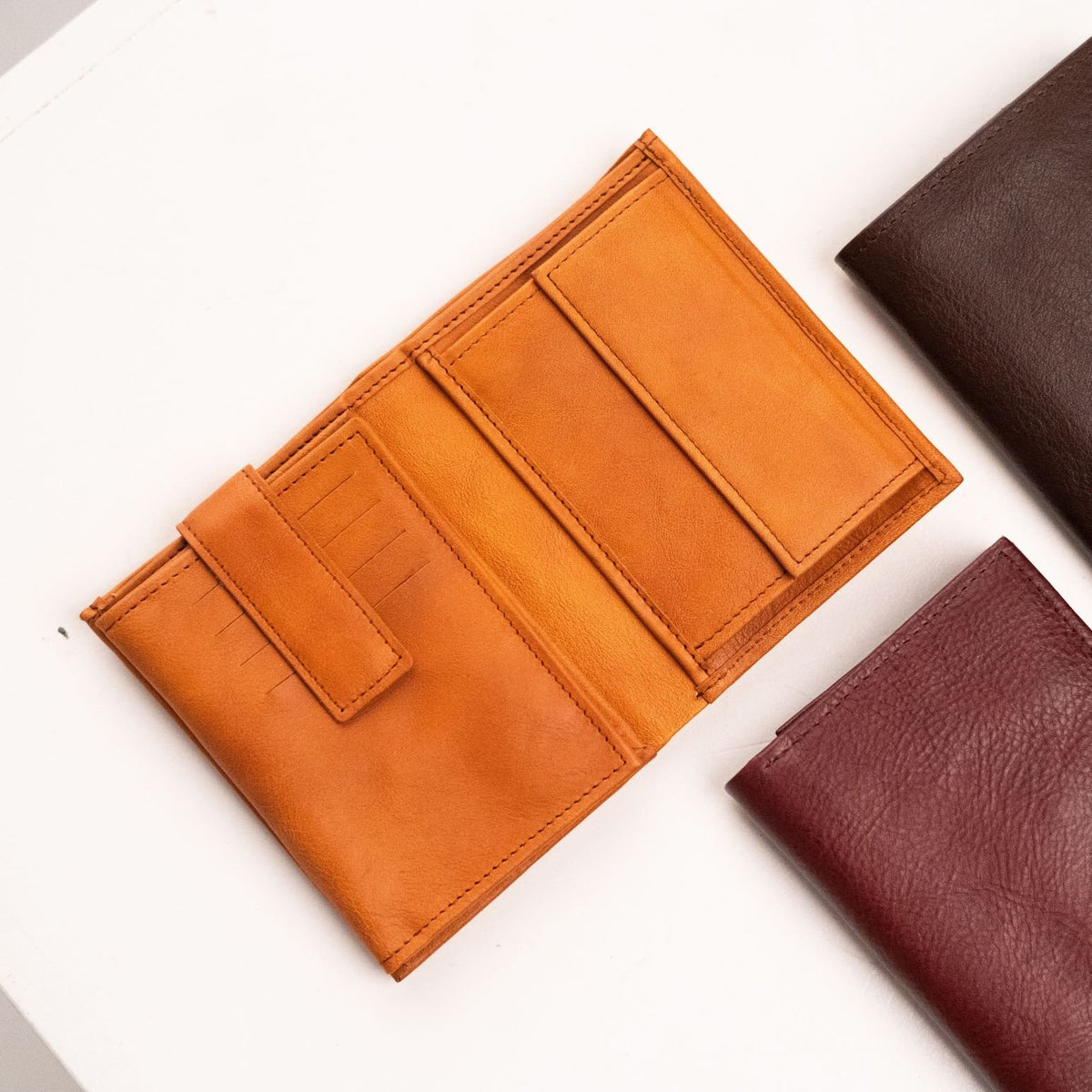 2. Open Cognac leather wallet by Papillon showing card slots and compartments
