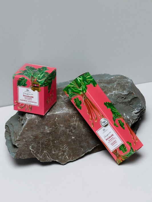 1. Woman holding Magrada Organic Cosmetics Rhubarb Hair Mask box, showcasing product packaging