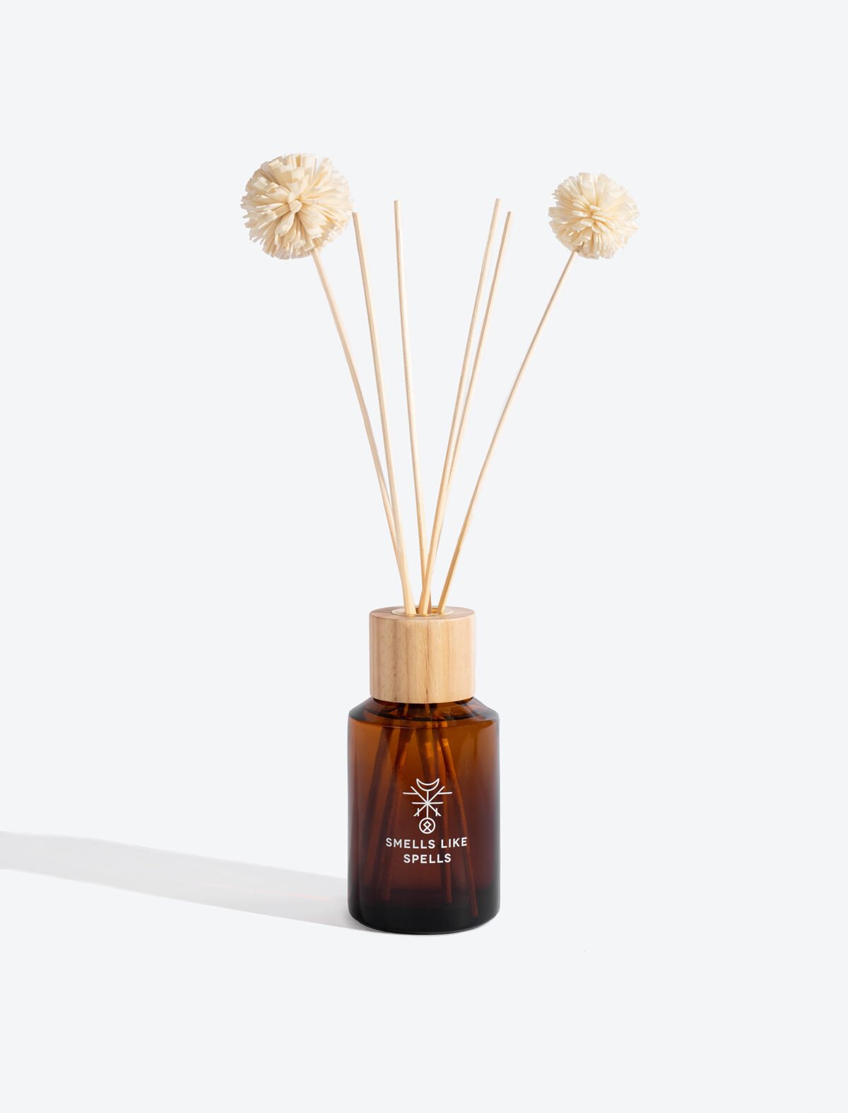3. Smells Like Spells Home Perfume ODIN in amber glass bottle with diffuser sticks, studio shot