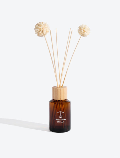 3. Smells Like Spells Home Perfume ODIN in amber glass bottle with diffuser sticks, studio shot
